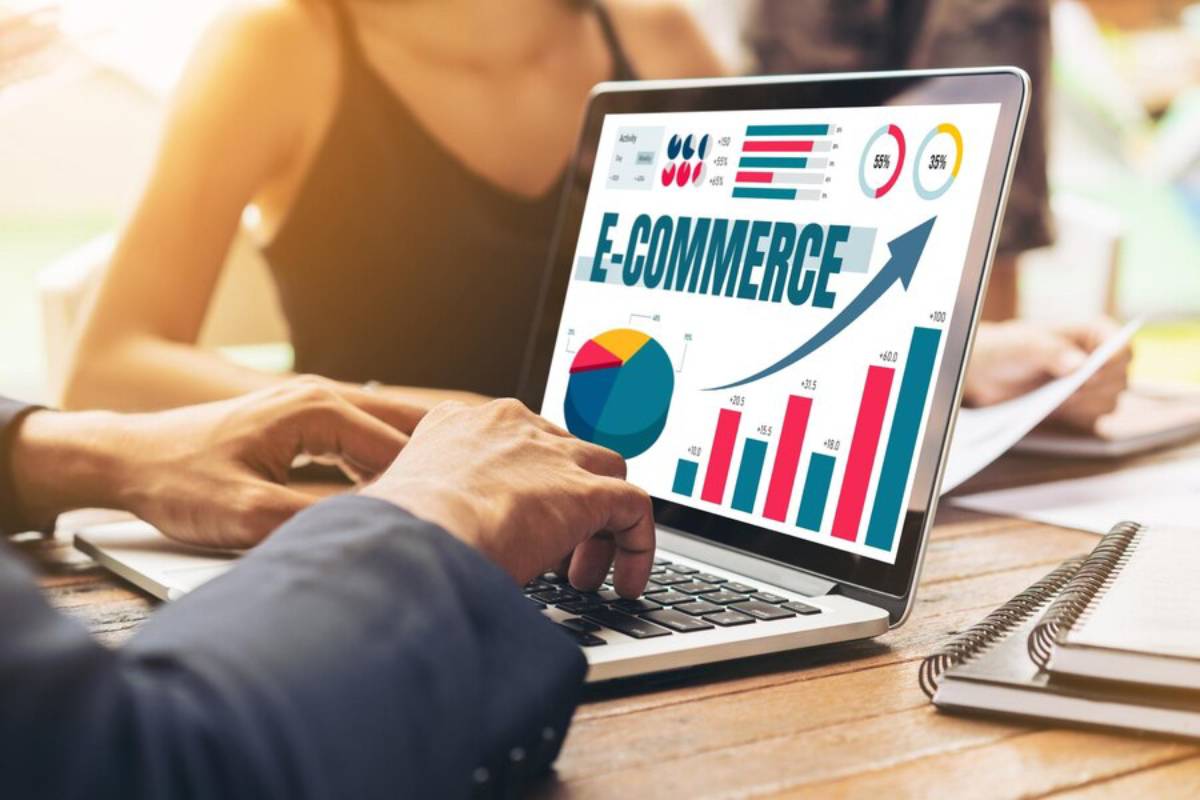 A person analyzes e-commerce data on a laptop, displaying charts and graphs indicating growth and performance metrics.